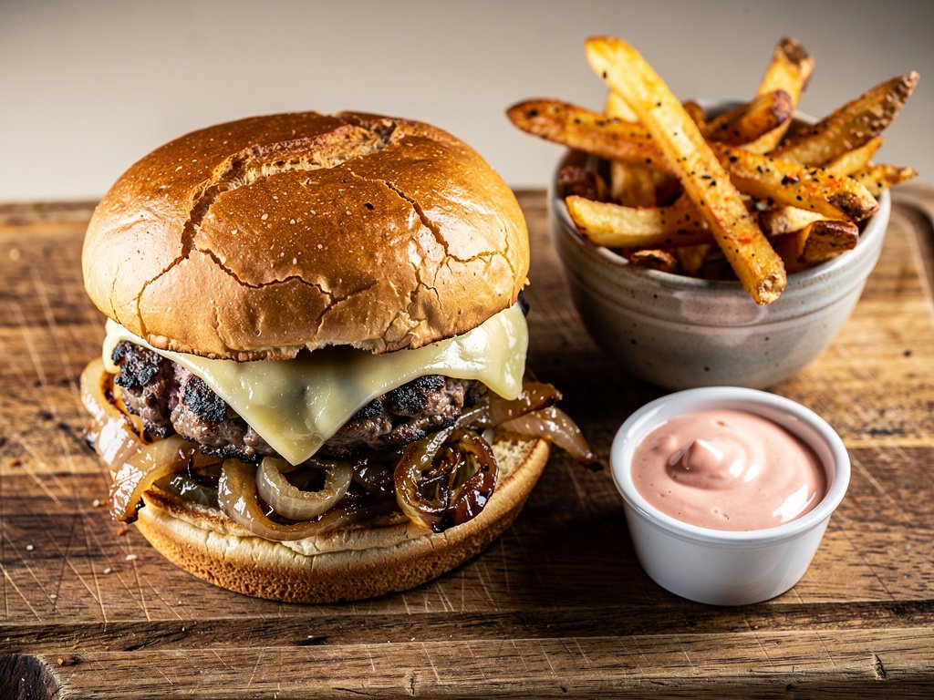 Crispy Smashed Burgers with White Cheddar, Caramelized Onions, and Old Bay Fries