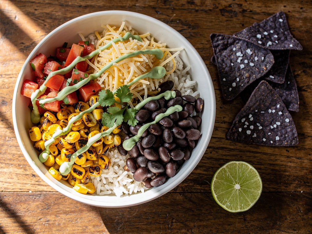 Smoky Black Bean and Charred Corn Burrito Bowls with Lime Crema